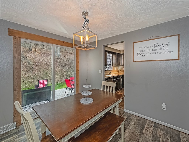 dining area with a wealth of natural light, dark hardwood / wood-style flooring, and a chandelier