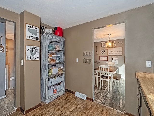 interior space featuring hardwood / wood-style floors and an inviting chandelier