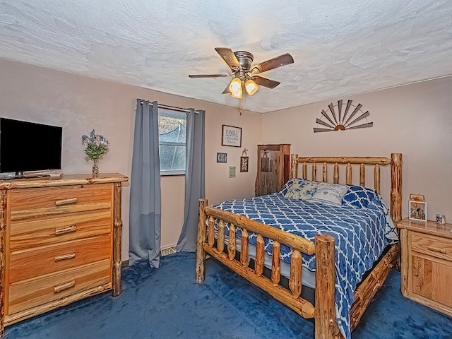 carpeted bedroom featuring ceiling fan and a textured ceiling