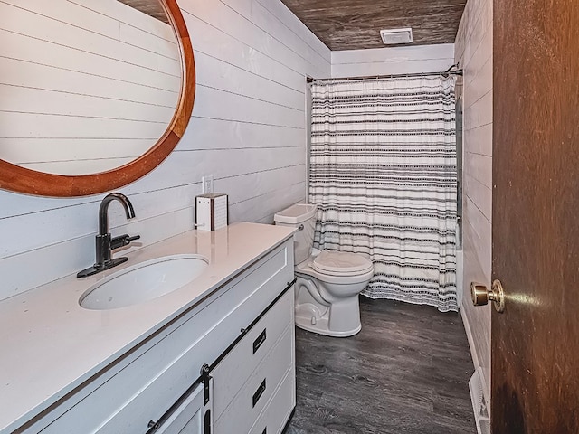 bathroom with hardwood / wood-style floors, vanity, toilet, and wood walls