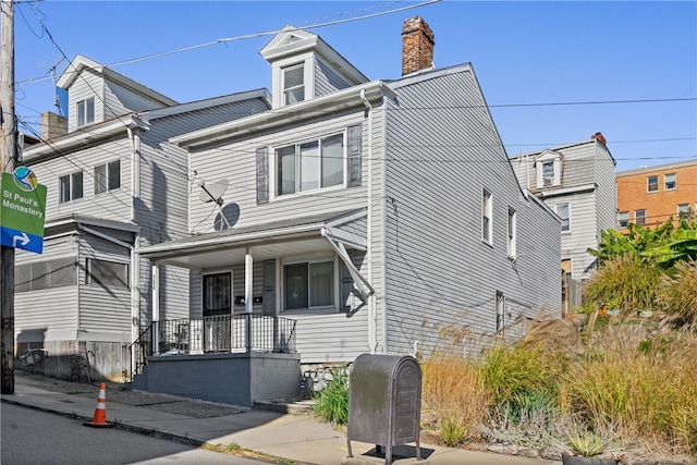 townhome / multi-family property featuring covered porch