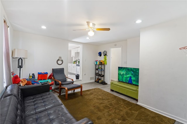 living room featuring hardwood / wood-style flooring and ceiling fan