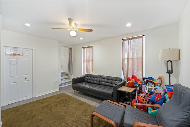 living room featuring light hardwood / wood-style floors and ceiling fan