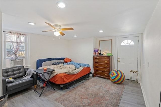 bedroom with light hardwood / wood-style floors and ceiling fan