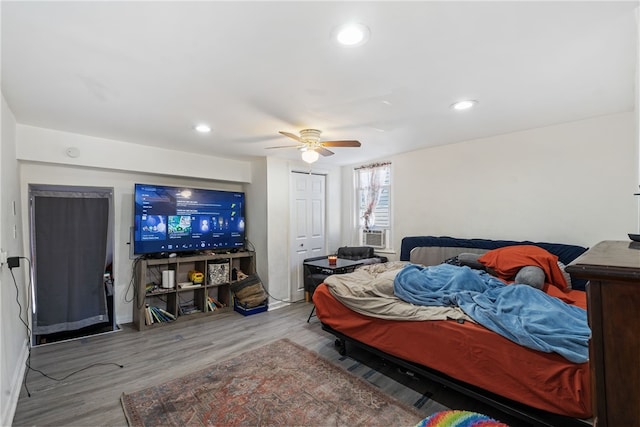 bedroom with hardwood / wood-style flooring and ceiling fan