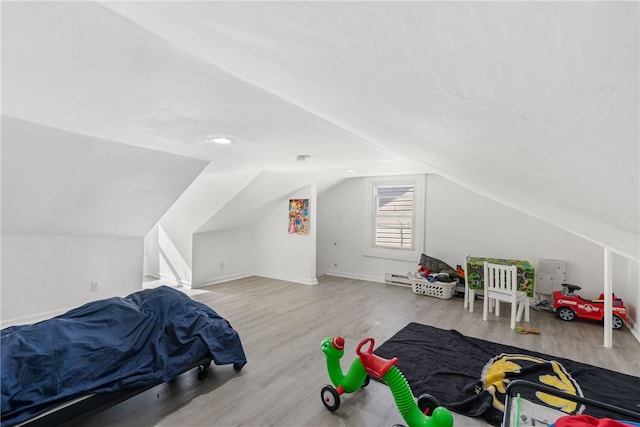 bedroom with vaulted ceiling and light hardwood / wood-style floors