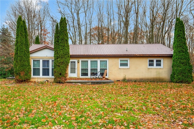 back of house with a lawn