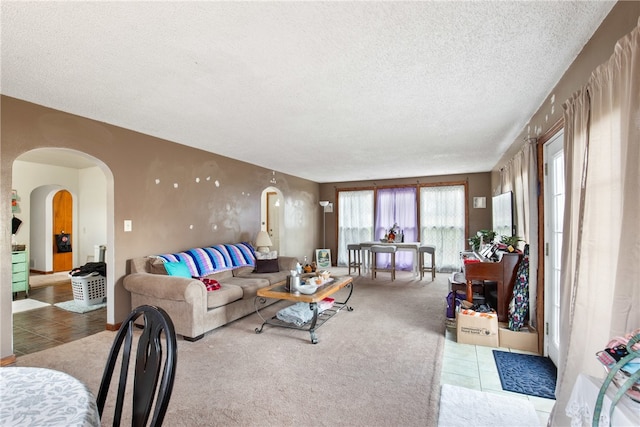 carpeted living room featuring a textured ceiling