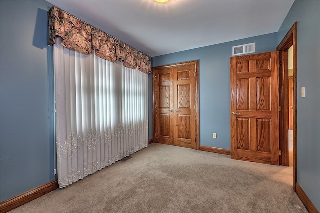 unfurnished bedroom with light colored carpet