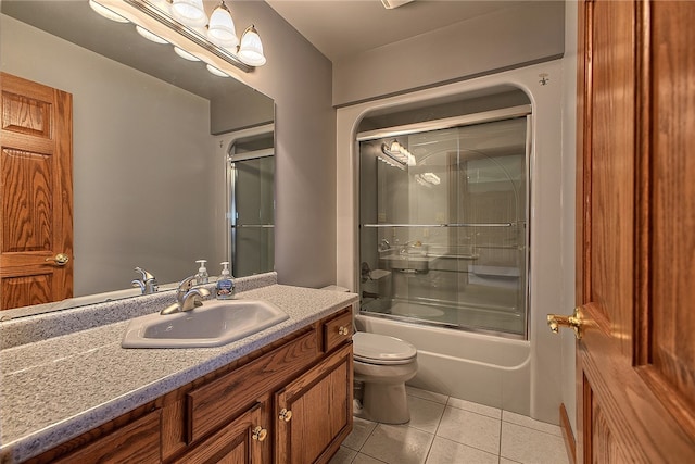 full bathroom featuring toilet, tile patterned floors, vanity, and shower / bath combination with glass door