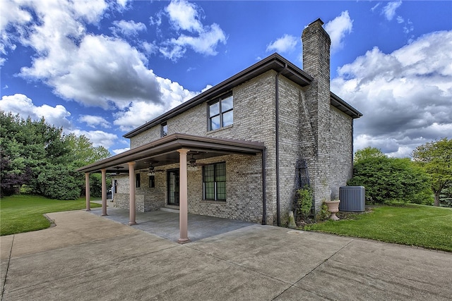 rear view of house with a patio, central AC, a lawn, and ceiling fan