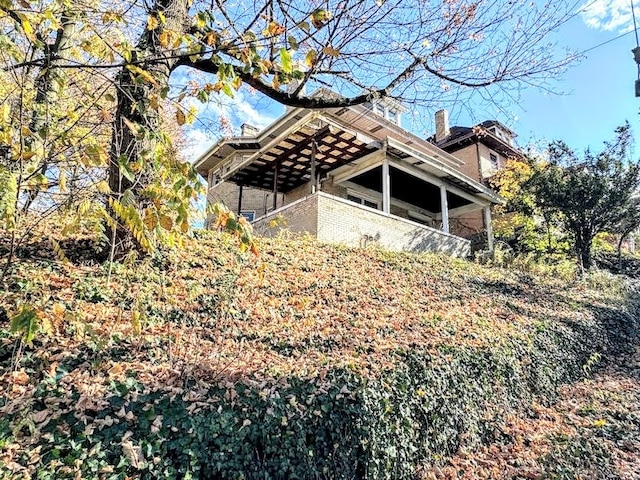 view of side of home with a sunroom