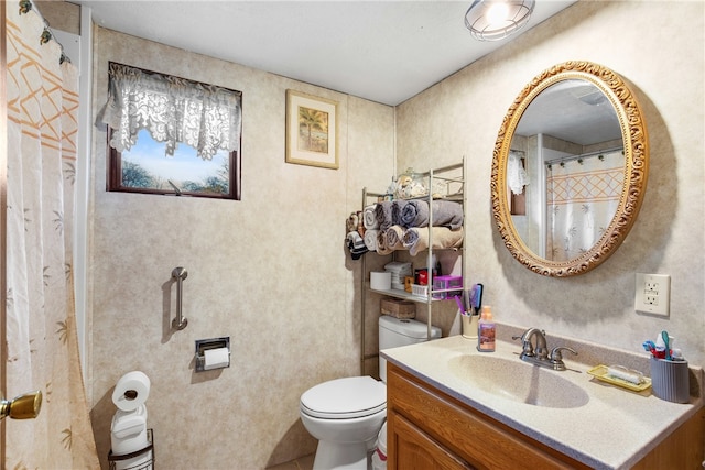 bathroom featuring vanity and toilet