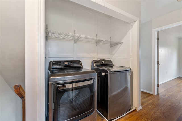 washroom featuring hardwood / wood-style floors and washing machine and clothes dryer