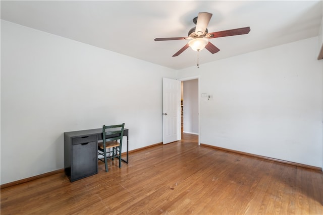 home office featuring hardwood / wood-style floors and ceiling fan