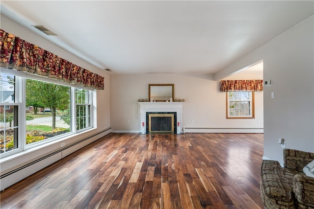 unfurnished living room featuring wood-type flooring and a baseboard radiator