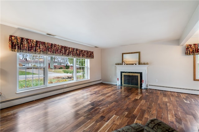 unfurnished living room with baseboard heating and hardwood / wood-style flooring