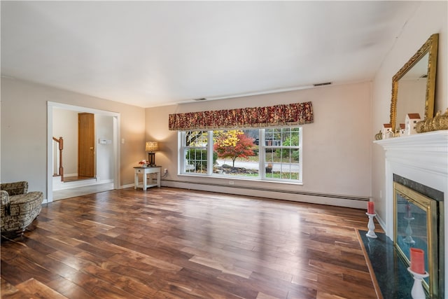 living room with baseboard heating, a fireplace, and hardwood / wood-style flooring