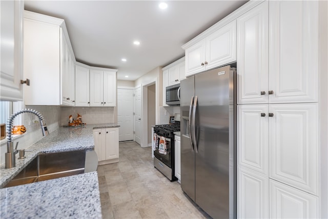 kitchen featuring white cabinets, sink, and stainless steel appliances