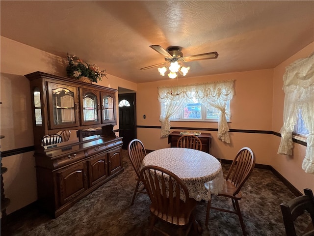 carpeted dining space featuring ceiling fan and a textured ceiling