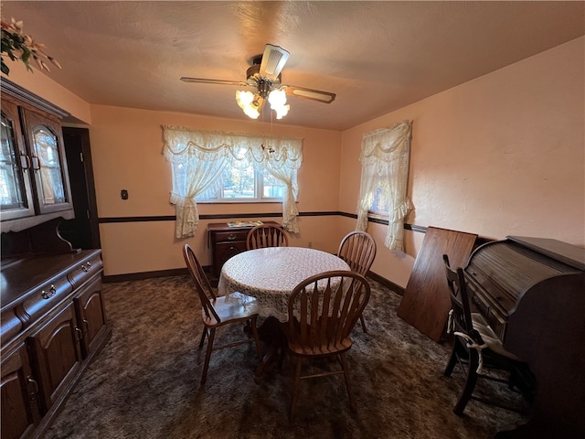 carpeted dining space with a textured ceiling and ceiling fan