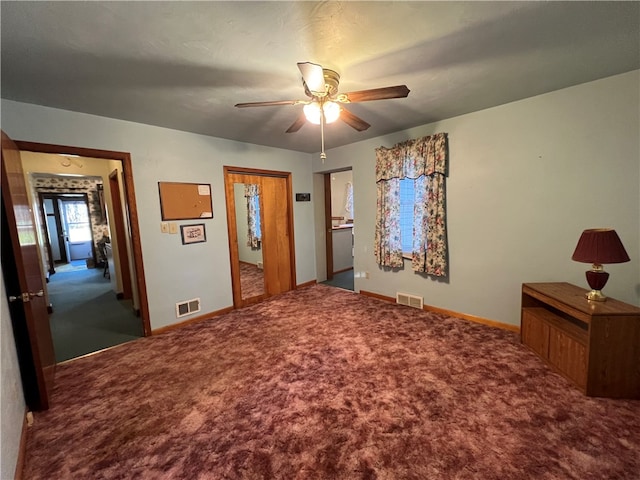 unfurnished bedroom featuring ceiling fan and carpet floors