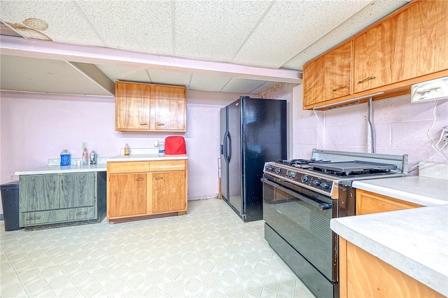 kitchen with a drop ceiling and black appliances