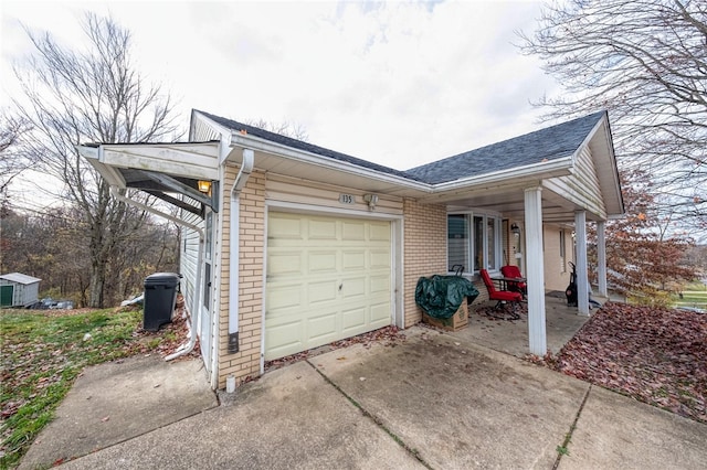 view of side of home featuring covered porch and a garage