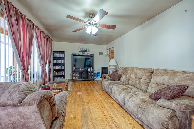 living room with ceiling fan and hardwood / wood-style floors