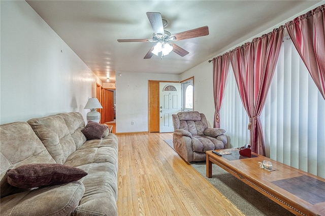 living room featuring ceiling fan and light wood-type flooring