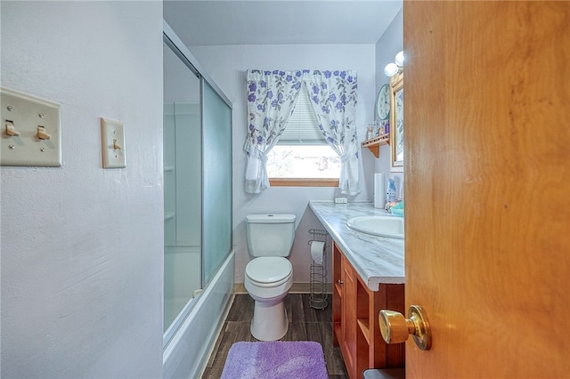 full bathroom with toilet, combined bath / shower with glass door, and vanity