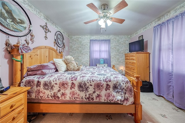 bedroom featuring ceiling fan and light carpet