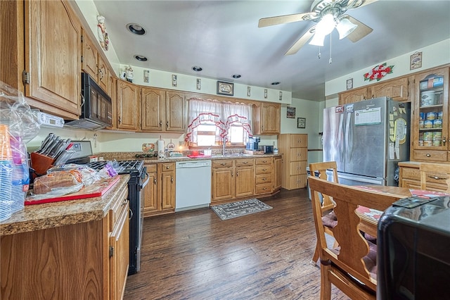 kitchen featuring ceiling fan, sink, black appliances, and dark hardwood / wood-style flooring