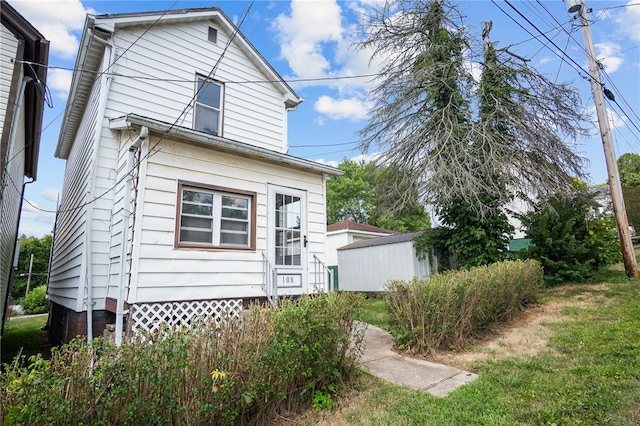 back of house with a yard