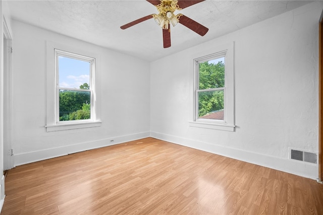 empty room featuring ceiling fan and light wood-type flooring