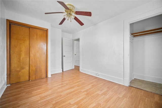 unfurnished bedroom with ceiling fan and light wood-type flooring