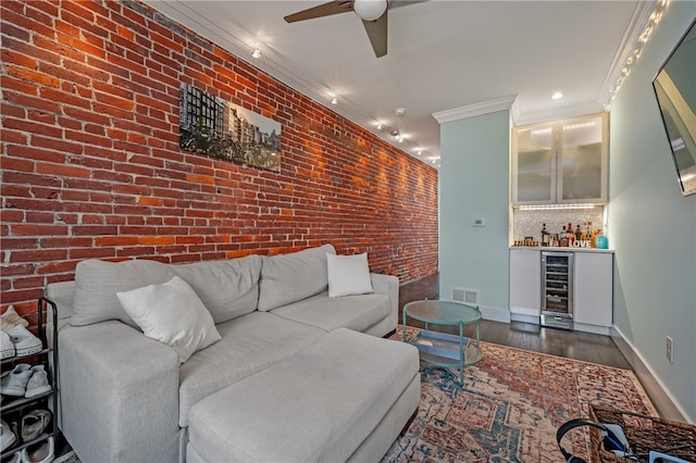 living room with ornamental molding, dark hardwood / wood-style flooring, brick wall, and beverage cooler