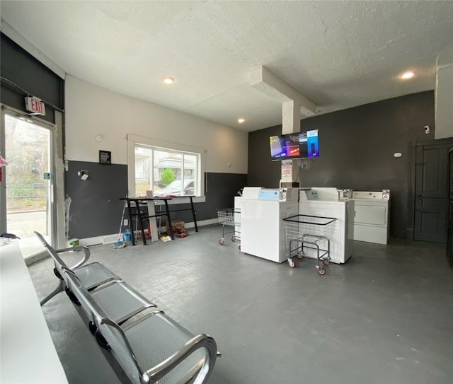 interior space featuring a textured ceiling and washing machine and clothes dryer