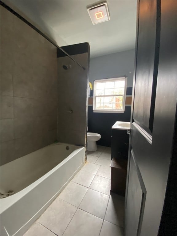 full bathroom with tile patterned flooring, vanity, toilet, and tiled shower / bath