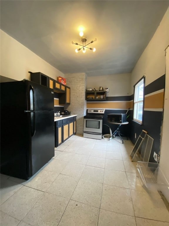 kitchen with black refrigerator and stainless steel range with electric stovetop