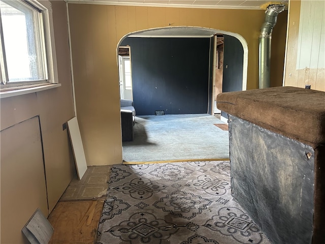 hall featuring light carpet and ornamental molding