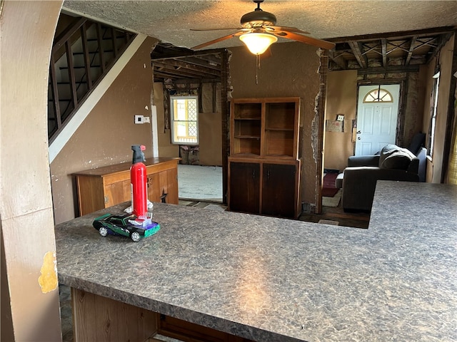 kitchen with ceiling fan and a textured ceiling