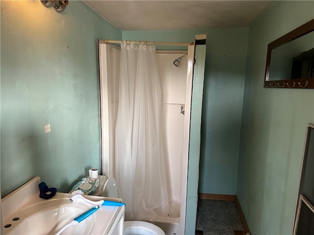 bathroom featuring toilet, vanity, and curtained shower