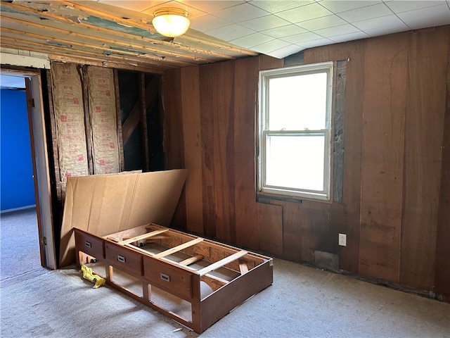 bedroom with carpet and wooden walls