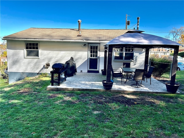 rear view of house with a yard and a patio area