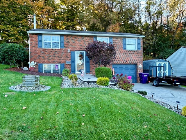raised ranch featuring driveway, a garage, a front yard, brick siding, and a storage shed