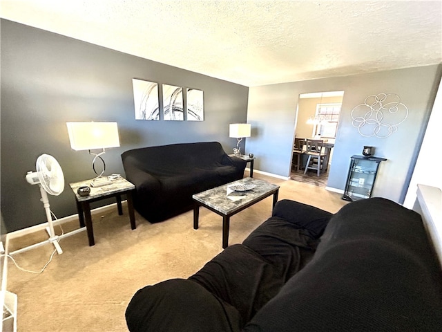 living room with a textured ceiling and light carpet