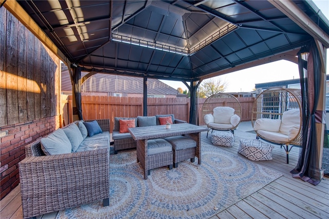 view of patio / terrace with a wooden deck, an outdoor living space, and a gazebo