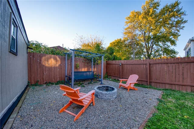 exterior space featuring a patio and an outdoor fire pit