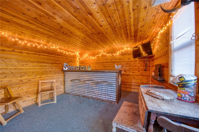 carpeted bedroom featuring wooden walls and wooden ceiling